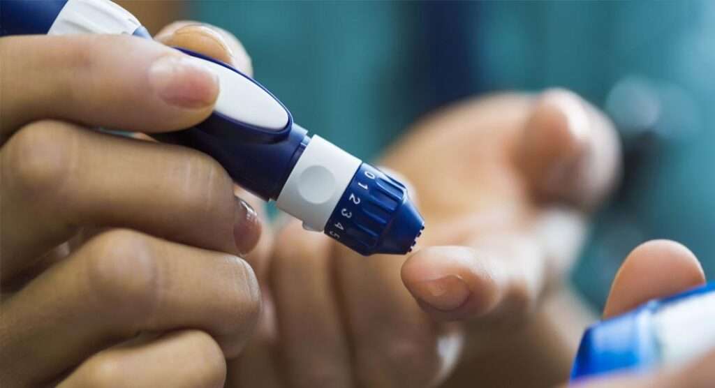 Hands holding a diabetes tester