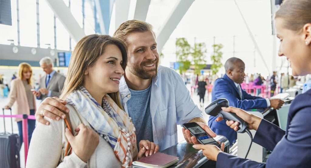 Young couple checking in at airport