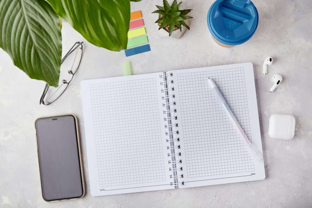 Inspiring Creativity - Clean Workspace with Open Notebook. Open Notebook and Pen Flat Lay