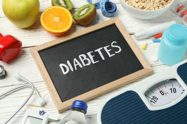 Word Diabetes and diabetic accessories on wooden background